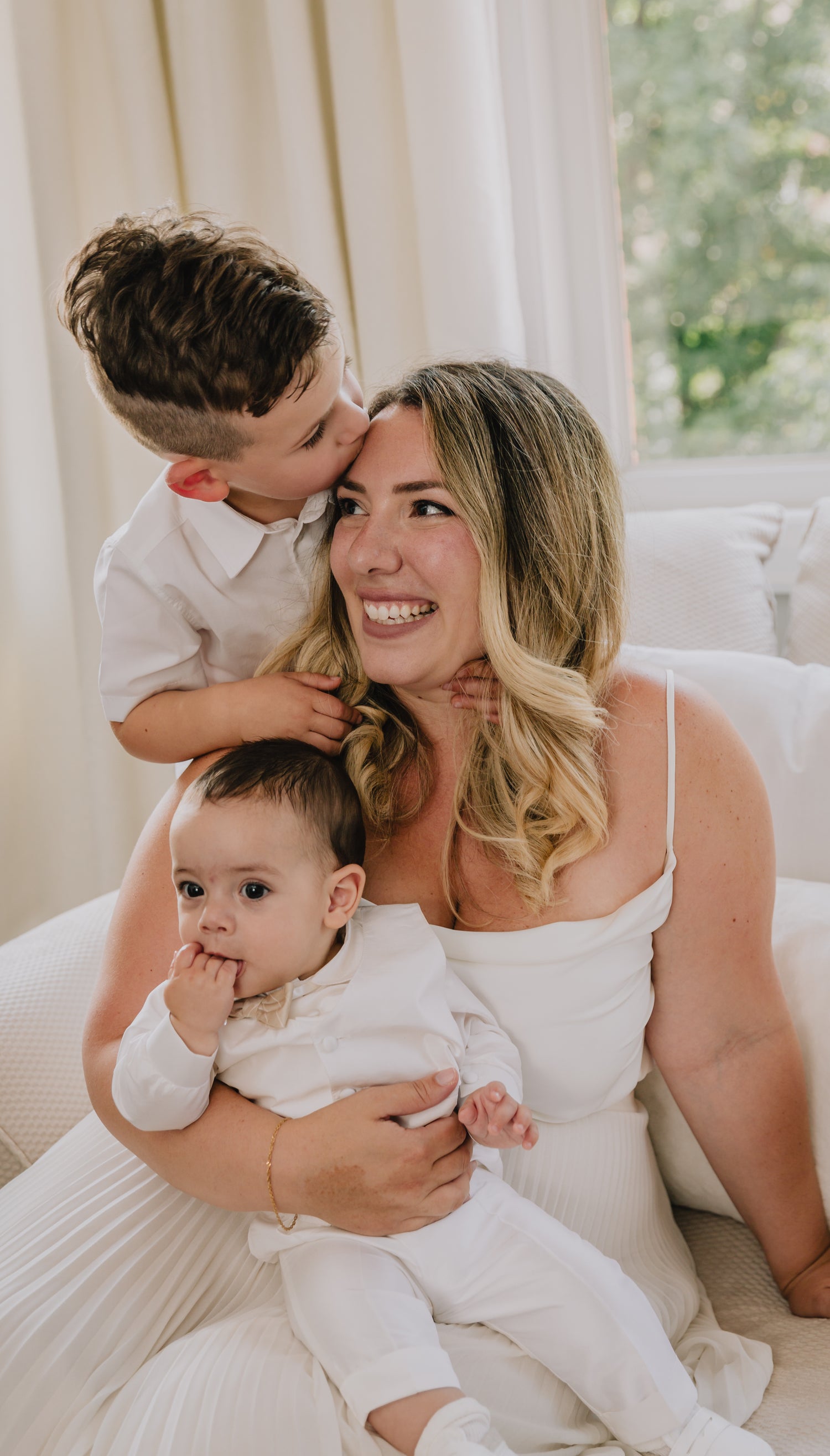 mom holding aby with young child